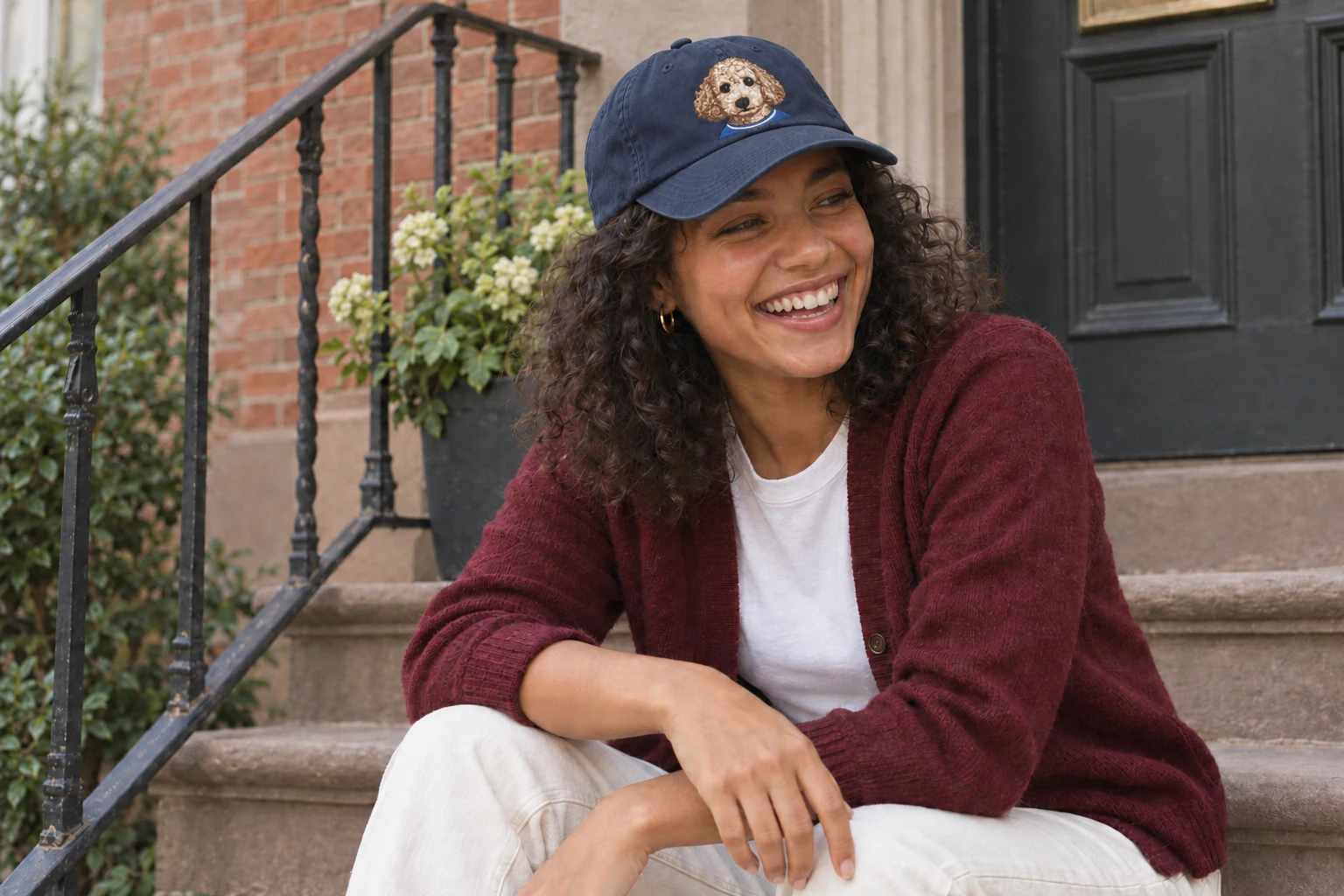 A woman wearing a navy House Mascot cap